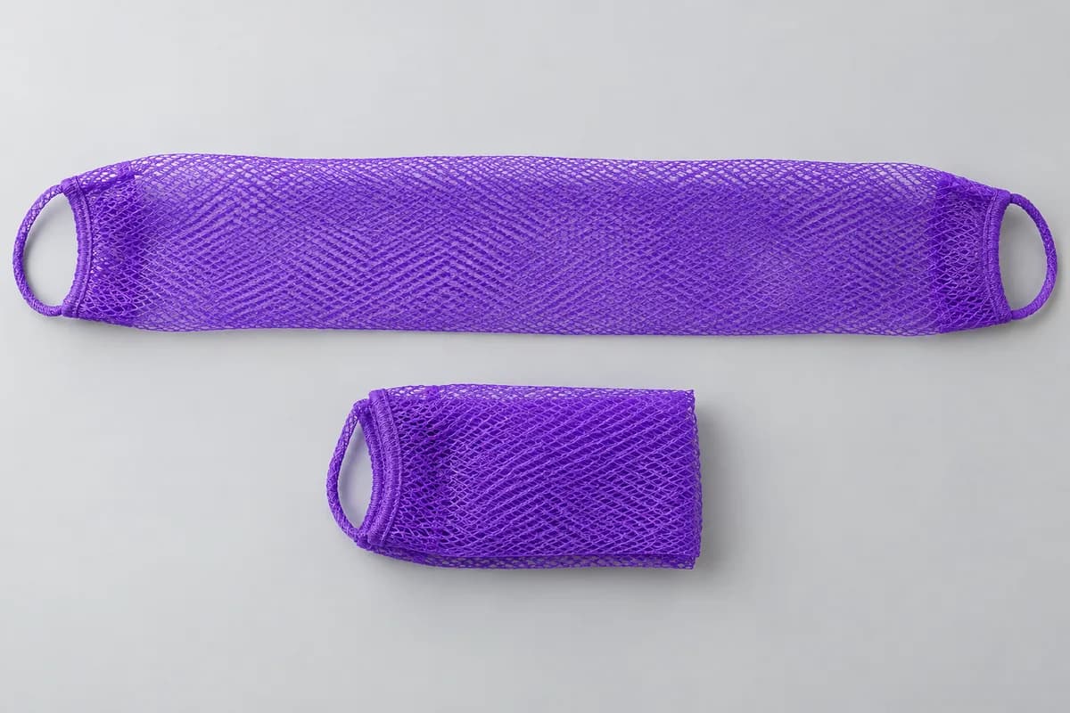 Illustrative rendering of a finished African net sponge shown unfolded and folded